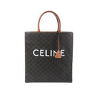 Front view of Celine Triomphe Vertical Cabas Large tote in black Triomphe-coated canvas with brown leather top handles and trim, large white CELINE logo, and hanging leather clochette.