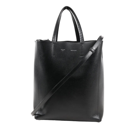CELINE Cabas Vertical Small handbag in black grained leather with top handles, slim crossbody strap, and minimalist silver branding on front.