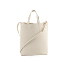 White Celine Small Vertical Cabas leather tote with two top handles, a long crossbody strap, and subtle logo stamp on a white background
