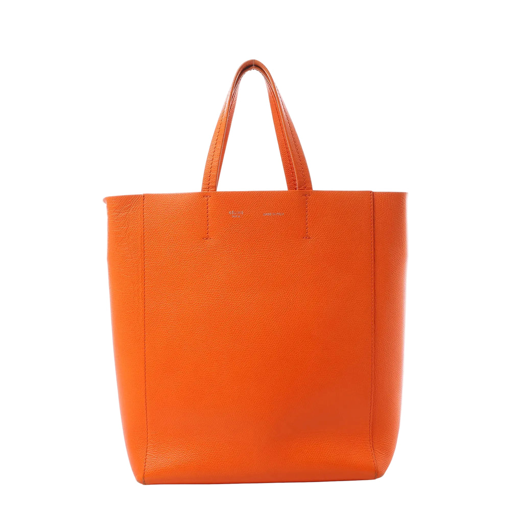 Orange Celine Small Vertical Cabas leather tote with two top handles and minimal logo stamp on the front, photographed on a white background