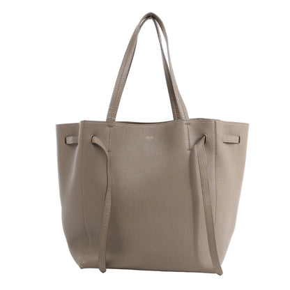 Celine Cabas Phantom Medium Shoulder Bag in taupe grained leather with slim top handles, adjustable side straps, and a structured open-top silhouette, shown against a white background.