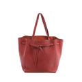 Celine Cabas Phantom Small shoulder bag in red grained leather with long handles, an open top and knotted front tie closure.