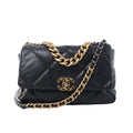 Chanel 19 Large black quilted leather shoulder bag with gold and silver-tone chain straps, leather-threaded strap, and CC turn-lock closure on white background.