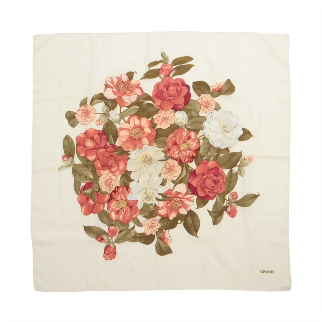 Beige Chanel silk handkerchief with a central bouquet of red, pink and white camellias, olive-green leaves and Chanel lettering in one corner.