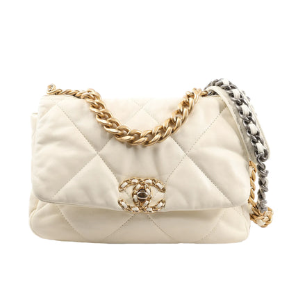 Chanel 19 2Way Handbag in ecru quilted leather, featuring gold and silver-tone chain shoulder straps, large interwoven CC turn-lock closure, and a soft, structured silhouette, displayed against a white background.