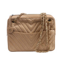 Beige Chanel leather shoulder bag with chevron quilting, gold-tone chain straps, top zip closure and round CC charm.