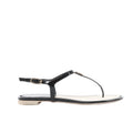Side view of a black Chanel flat thong sandal with glossy patent straps, a gold-tone ankle buckle and a pale footbed with black stitching.