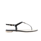 Side view of a black Chanel flat thong sandal with glossy patent straps, a gold-tone ankle buckle and a pale footbed with black stitching.