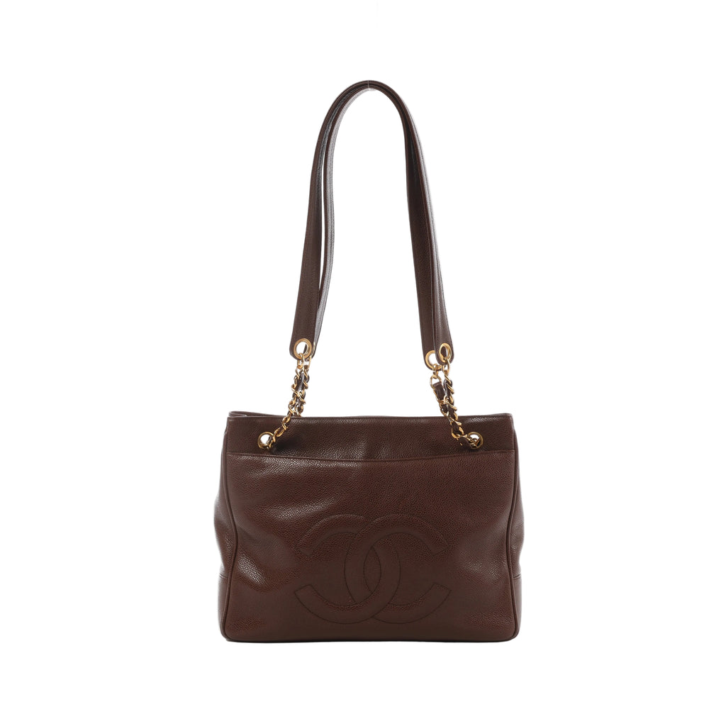 Brown Chanel caviar leather shoulder bag with oversized stitched CC logo, leather-woven gold-tone chain straps and pebbled texture.