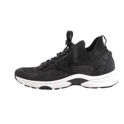 Side view of black CHANEL Coco Mark Knit Sneakers in size 40.5 EU, featuring a mixed-material upper with mesh, suede, and knit textures, tonal laces, and a white chunky sole, with the iconic CC logo on the side.