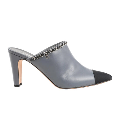CHANEL Coco Mark mule sandals in gray leather with a black fabric cap toe, silver-tone chain trim along the top edge, and high heel. Slip-on style, size 40.5 EU.