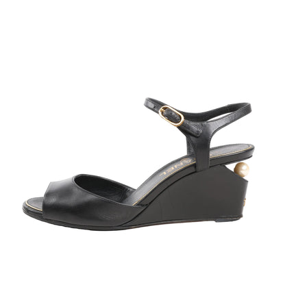 CHANEL Coco Mark black leather wedge sandals with ankle strap, gold-tone buckle, and pearl detail on the heel, size 38 EU.