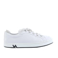 Pair of white Hermès low-top leather sneakers with white laces displayed on a cream Hermès dust bag.