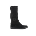 Chanel black suede boots with quilted matelassé shaft, round toe, rubber sole, and Coco logo patch on the side on white background