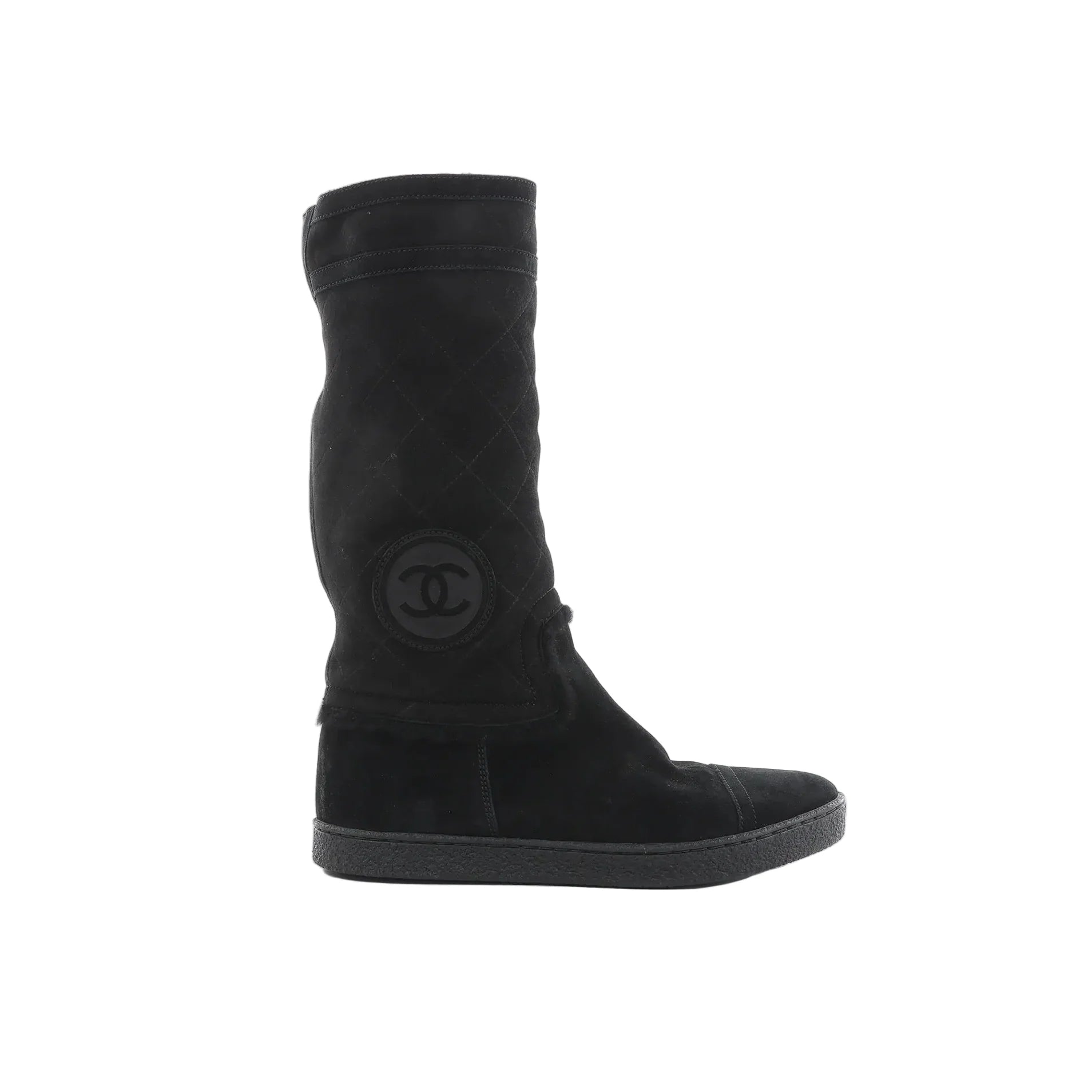 Chanel black suede boots with quilted matelassé shaft, round toe, rubber sole, and Coco logo patch on the side on white background