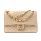 Front view of a beige Chanel quilted leather flap bag with a gold-tone CC turn-lock and leather-woven chain strap on a white background.