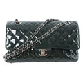 Chanel Classic Medium Double Flap shoulder bag in green quilted patent leather with silver-tone CC turn-lock closure and leather-woven double chain strap, displayed against a white background.
