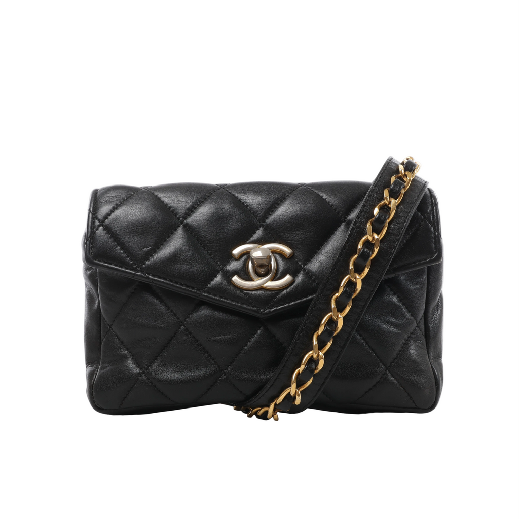 Front view of a black Chanel quilted leather waist bag with an envelope-style flap, gold-tone CC turn-lock and leather-interwoven chain belt.