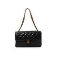 Black Chanel patent leather shoulder bag with diamond quilting, gold-tone CC turn-lock and black leather-woven chain strap.