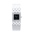 Chanel Matelassé stainless steel watch with black square dial, polished square case, quilted bracelet pattern, silver-tone hands and side crown on white background.