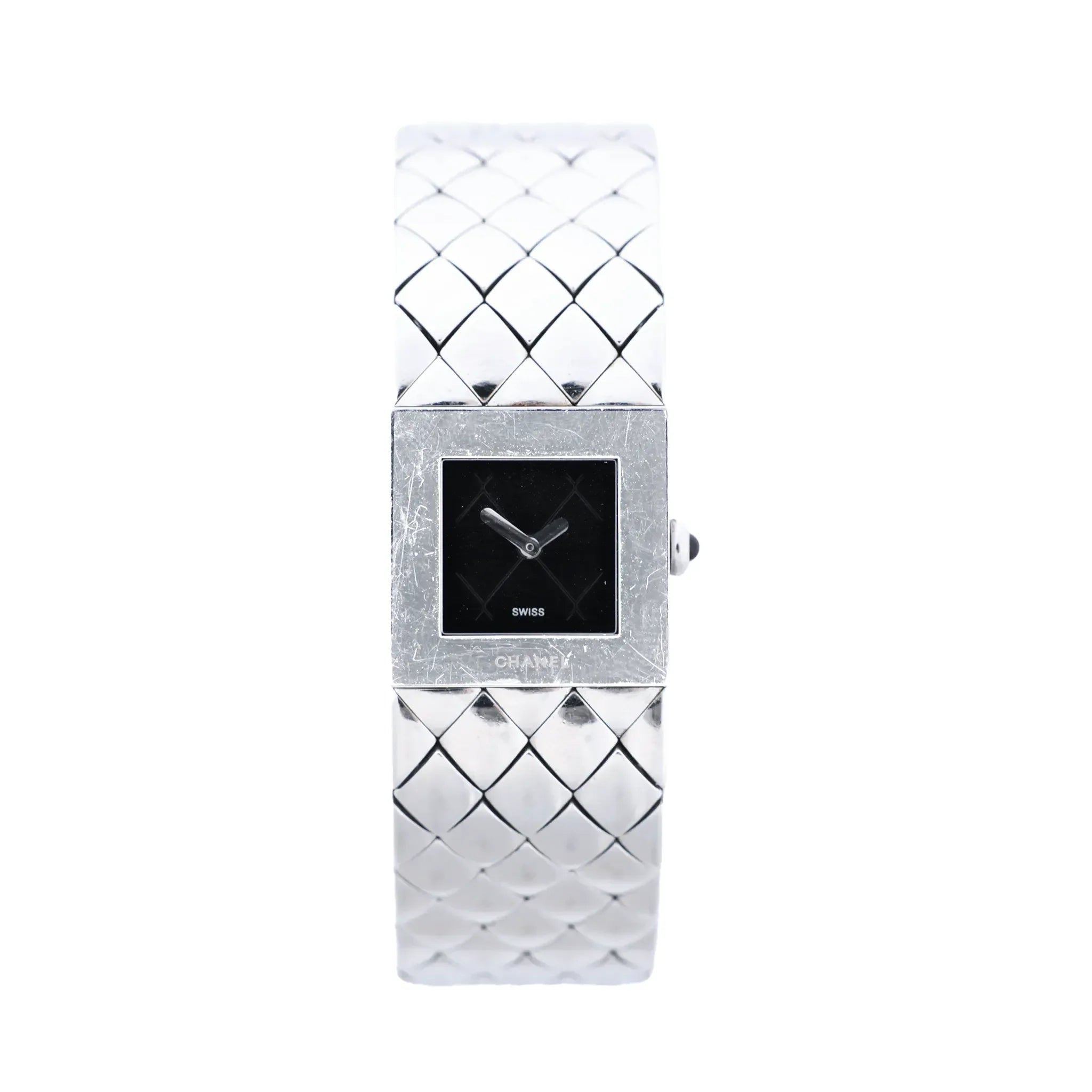Chanel Matelassé stainless steel watch with black square dial, polished square case, quilted bracelet pattern, silver-tone hands and side crown on white background.
