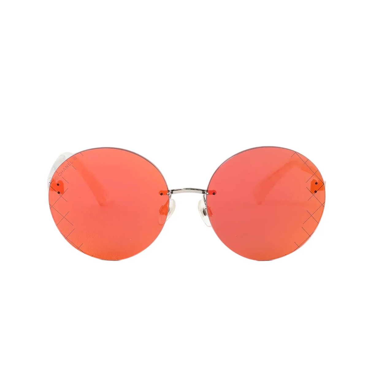 Front view of Chanel round sunglasses with red mirrored lenses and a slim silver-tone bridge on a white background.