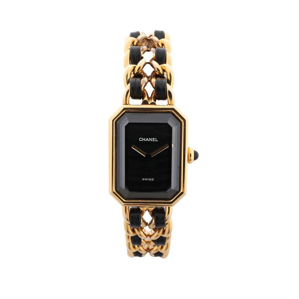 Chanel Première watch with rectangular black dial, gold-tone geometric case and chain bracelet woven with black leather.