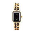 Front view of Chanel Première L watch with black dial, gold-tone rectangular octagonal bezel, and gold chain bracelet interwoven with black leather.