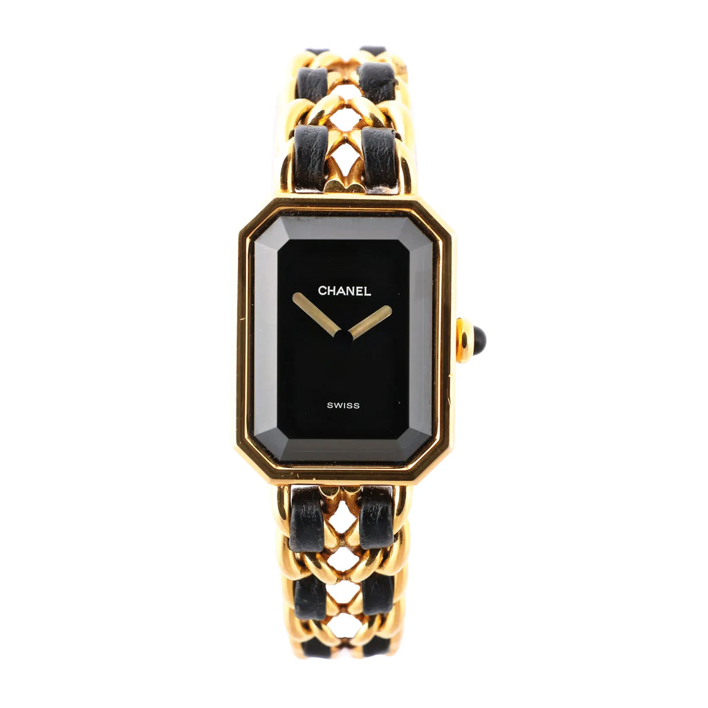Chanel Premiere L H6951 Q.E.32638 women's watch with a rectangular black dial, gold-plated bezel, and black leather-woven gold chain bracelet, showcasing a minimalist face with gold hands and Swiss quartz craftsmanship.