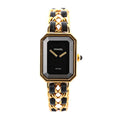 Chanel Premiere L H6951 Q.E.32638 women's watch with a rectangular black dial, gold-plated bezel, and black leather-woven gold chain bracelet, showcasing a minimalist face with gold hands and Swiss quartz craftsmanship.