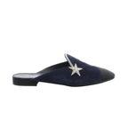 Chanel navy suede mule with black toe cap, rhinestone star embellishment, and low black heel, shown in side profile.