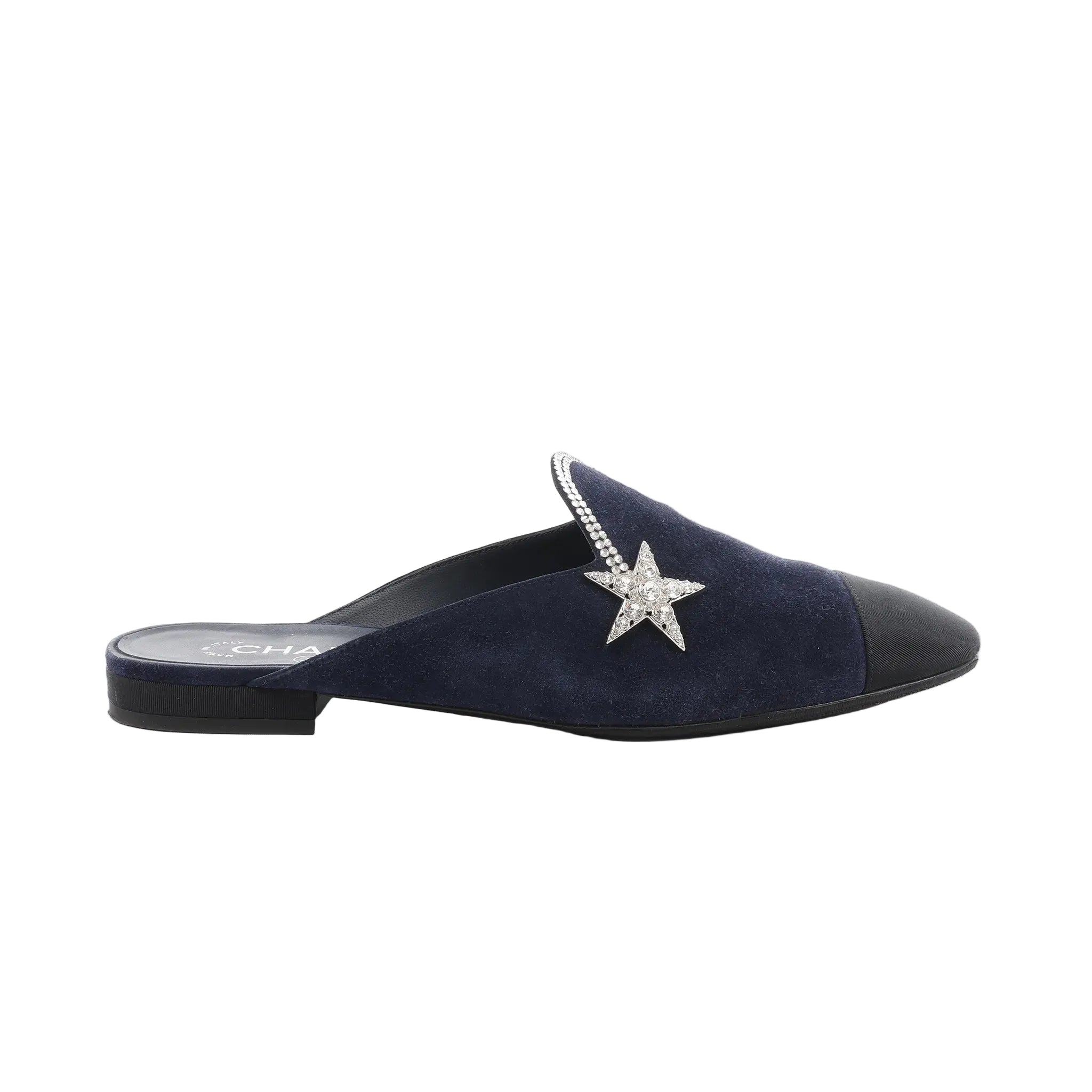 Chanel navy suede mule with black toe cap, rhinestone star embellishment, and low black heel, shown in side profile.