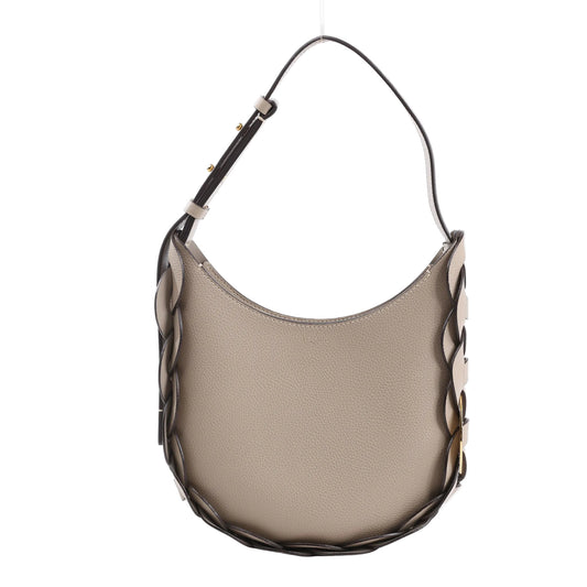 Chloé Darryl Shoulder Bag in taupe grained leather, featuring a rounded hobo silhouette, dark brown interlaced leather detailing along the edges, and an adjustable shoulder strap with gold-tone hardware, displayed against a white background.