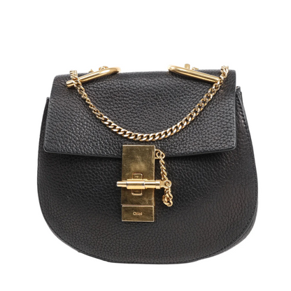 Chloé Drew shoulder bag in black pebbled leather with gold-tone chain strap, front flap, and signature turn-lock closure.
