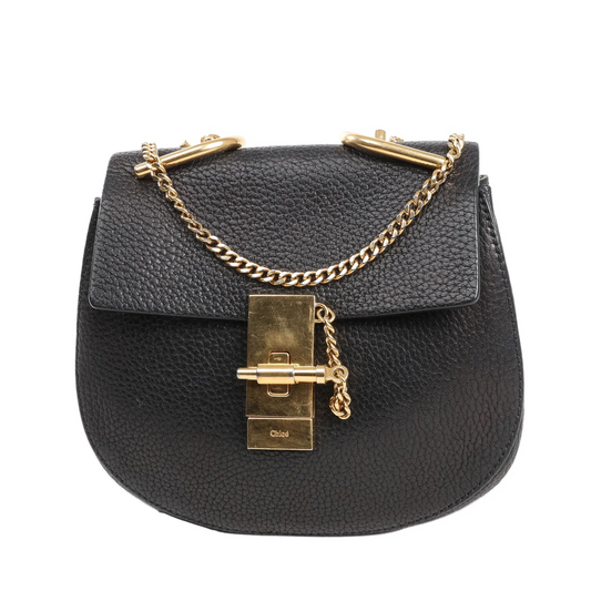 Chloé Drew shoulder bag in black pebbled leather with gold-tone chain strap, front flap, and signature turn-lock closure.