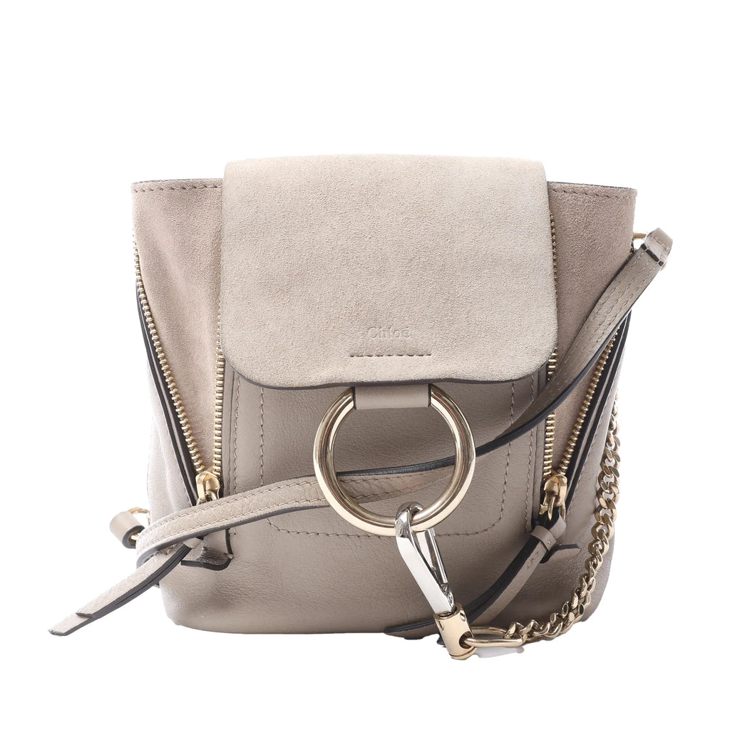 Chloé Faye beige leather and suede backpack with front flap, side zips, gold-tone ring hardware, chain detail and slim shoulder straps.