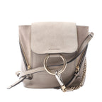 Chloé Faye beige leather and suede backpack with front flap, side zips, gold-tone ring hardware, chain detail and slim shoulder straps.