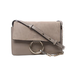 Beige Chloé Faye shoulder bag with suede flap, smooth leather body, adjustable leather strap, gold-tone ring and chain hardware.