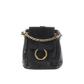 Chloé Faye black leather and suede backpack with gold-tone chain detail and large gold ring on front flap, front view on white background.