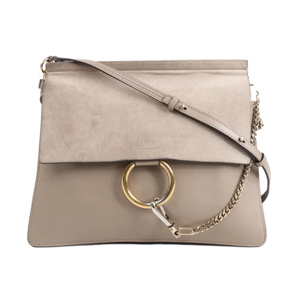 Chloé Faye Shoulder Bag in greige, featuring a mix of suede and leather, with a gold-tone ring and chain detail, adjustable leather strap, and flap closure, displayed against a white background.