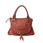 Chloé Marcie Medium handbag in warm brown leather with wrapped top handles, curved front stitching, top zip and gold-tone hardware.