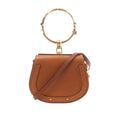 Brown Chloé Nile leather handbag with rounded saddle shape, large gold-tone bracelet handle and slim shoulder strap.