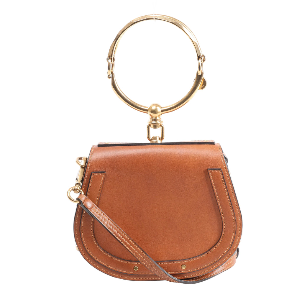 Brown Chloé Nile leather handbag with rounded saddle shape, large gold-tone bracelet handle, slim leather shoulder strap and gold-tone hardware.