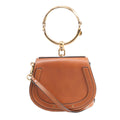 Brown Chloé Nile leather handbag with rounded saddle shape, large gold-tone bracelet handle, slim leather shoulder strap and gold-tone hardware.