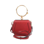 Chloé Nile Small bag in red leather with a large gold-tone bracelet handle, detachable shoulder strap and compact curved silhouette.