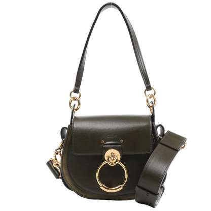 Front view of the Chloé Tess Small Leather 2Way Handbag in green, featuring a rounded saddle shape, flap closure with oversized gold-tone ring detail, top handle, and wide detachable shoulder strap, displayed against a white background.