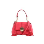 Chloé Penelope pink leather handbag with top handle, braided trim, gold-tone round clasp, tassel accents, and detachable shoulder strap, front view on white background.