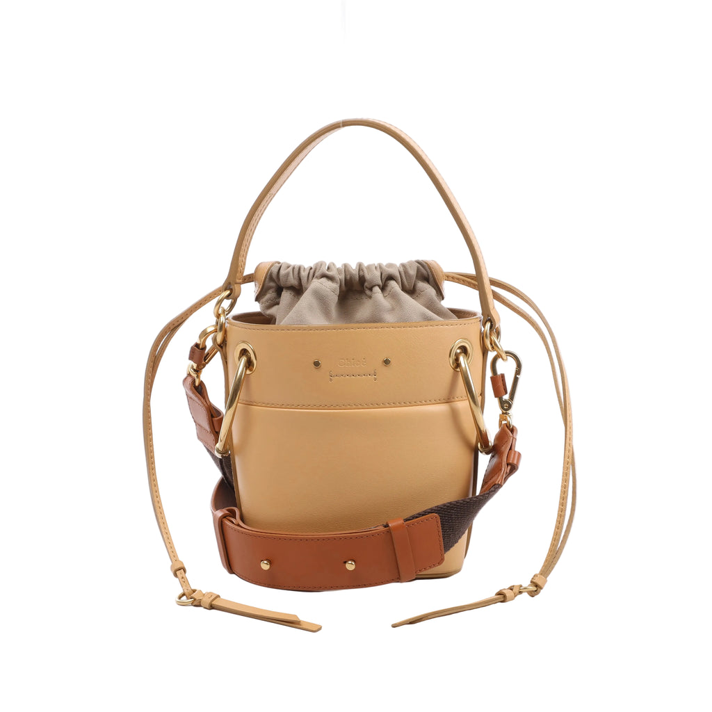 Beige Chloé Roy leather shoulder bag with gathered canvas drawstring insert, top handle, two shoulder straps and gold-tone ring hardware.