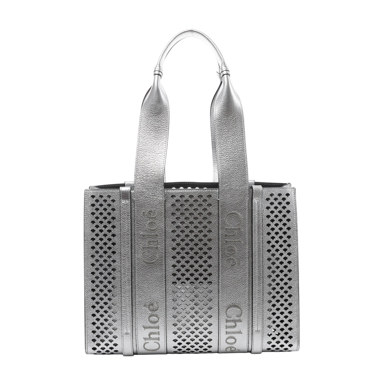 Metallic silver Chloé Woody Medium leather tote bag with perforated panels, wide shoulder handles and repeated Chloé logo detailing.