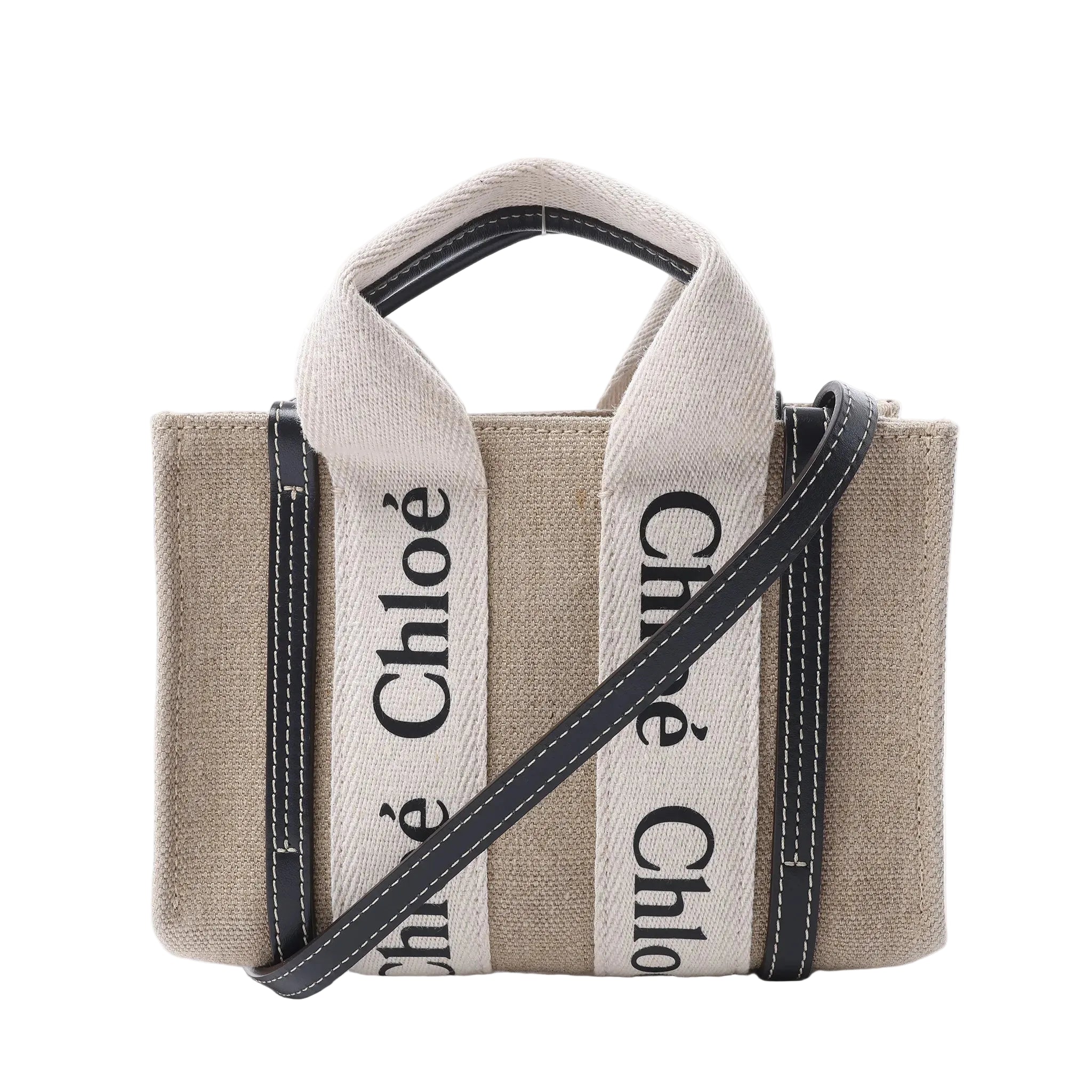 Chloé Woody Mini beige canvas handbag with black leather trim, cream logo webbing handles and a detachable black shoulder strap.